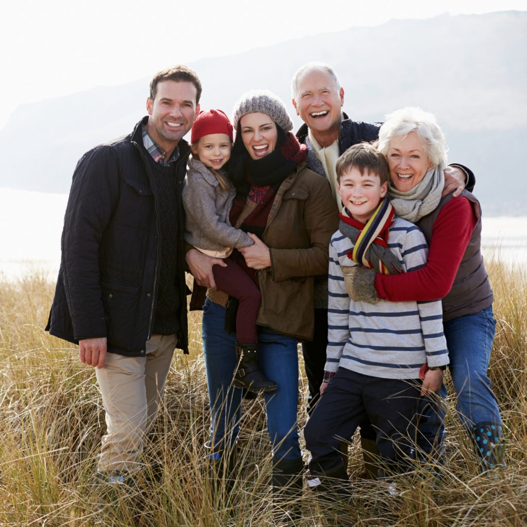 family standing in a field at twilight